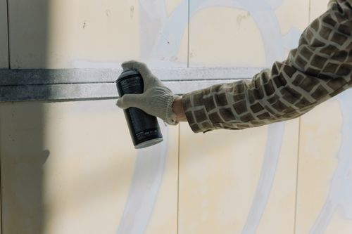 Free A close-up view of a person spray painting a wall with precision and creativity. Stock Photo