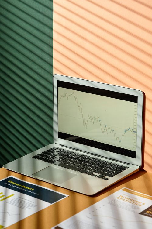 Laptop displaying data charts on a sunlit office desk