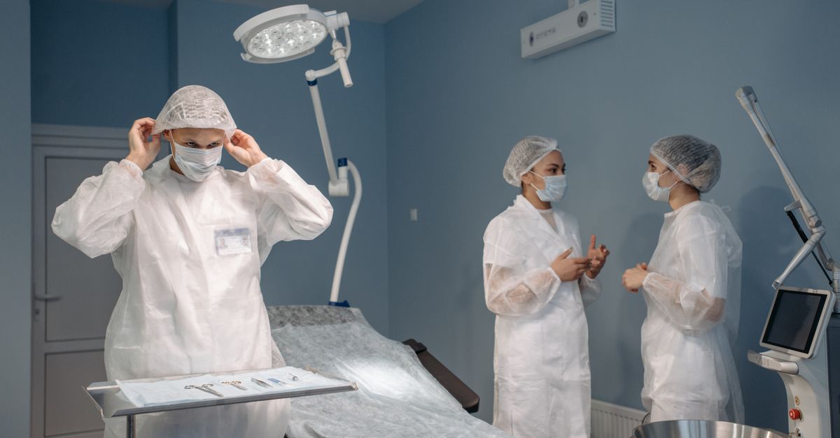 Nurses preparing equipment and supplies in an ambulatory surgery center operating room