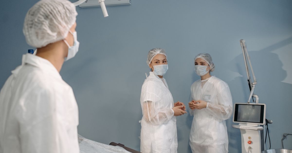 semiconductor fabrication plant clean room workers in protective suits