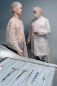 Medical professionals in sterile attire with surgical tools ready for a procedure.