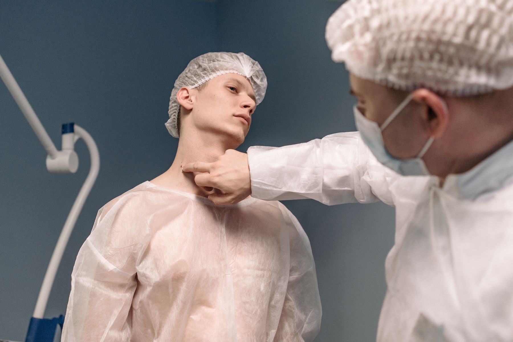 Clinician examining a patient's neck during a thyroid health assessment