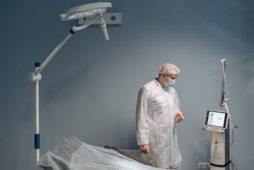 A Man Standing Beside the Medical Equipment