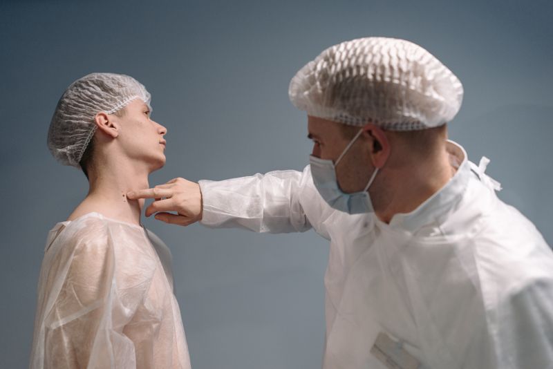 A doctor evaluates a patient's skin condition in a clinical setting with appropriate medical attire.