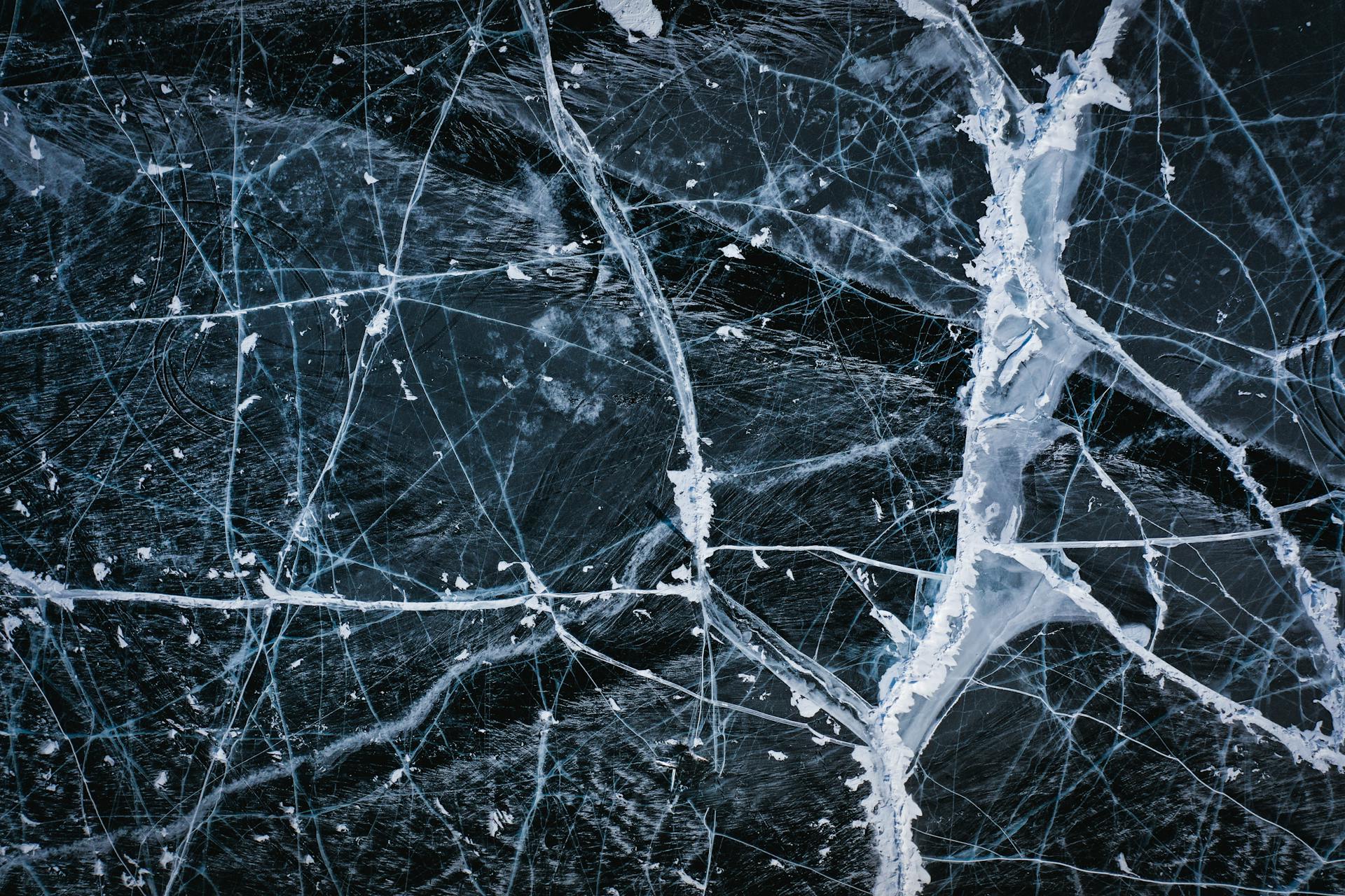 Textured background of icy lake with cracks