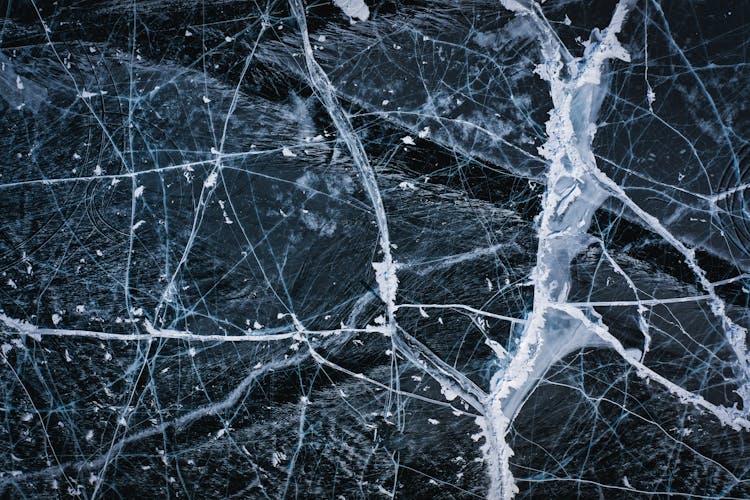 Textured Background Of Icy Lake With Cracks