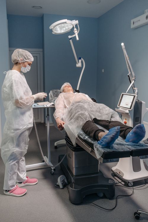 Free Healthcare professional assists patient before procedure in modern medical facility. Stock Photo