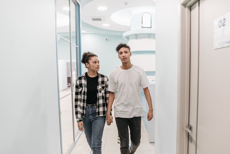 Two People In A Hospital Corridor