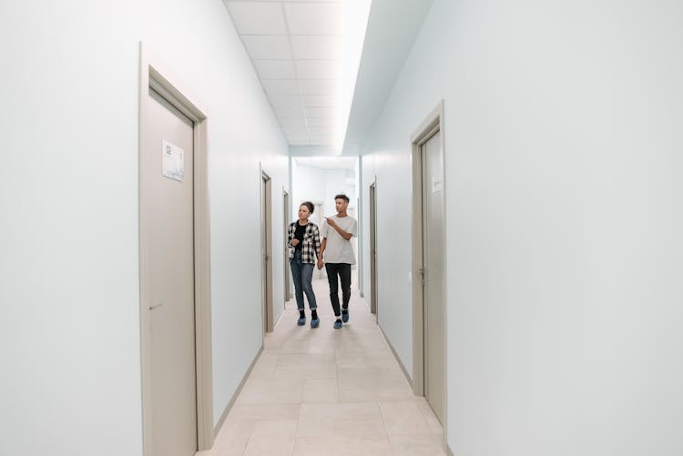 Couple Searching Examination Room In Hospital