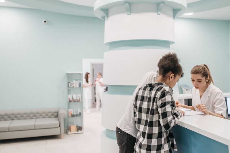 Staff at a modern clinic reception desk — photo by Pavel Danilyuk on Pexels