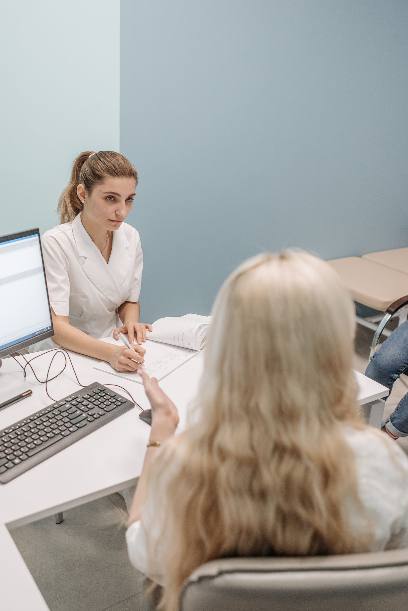 Healthcare professional speaking with a patient during a clinical consultation