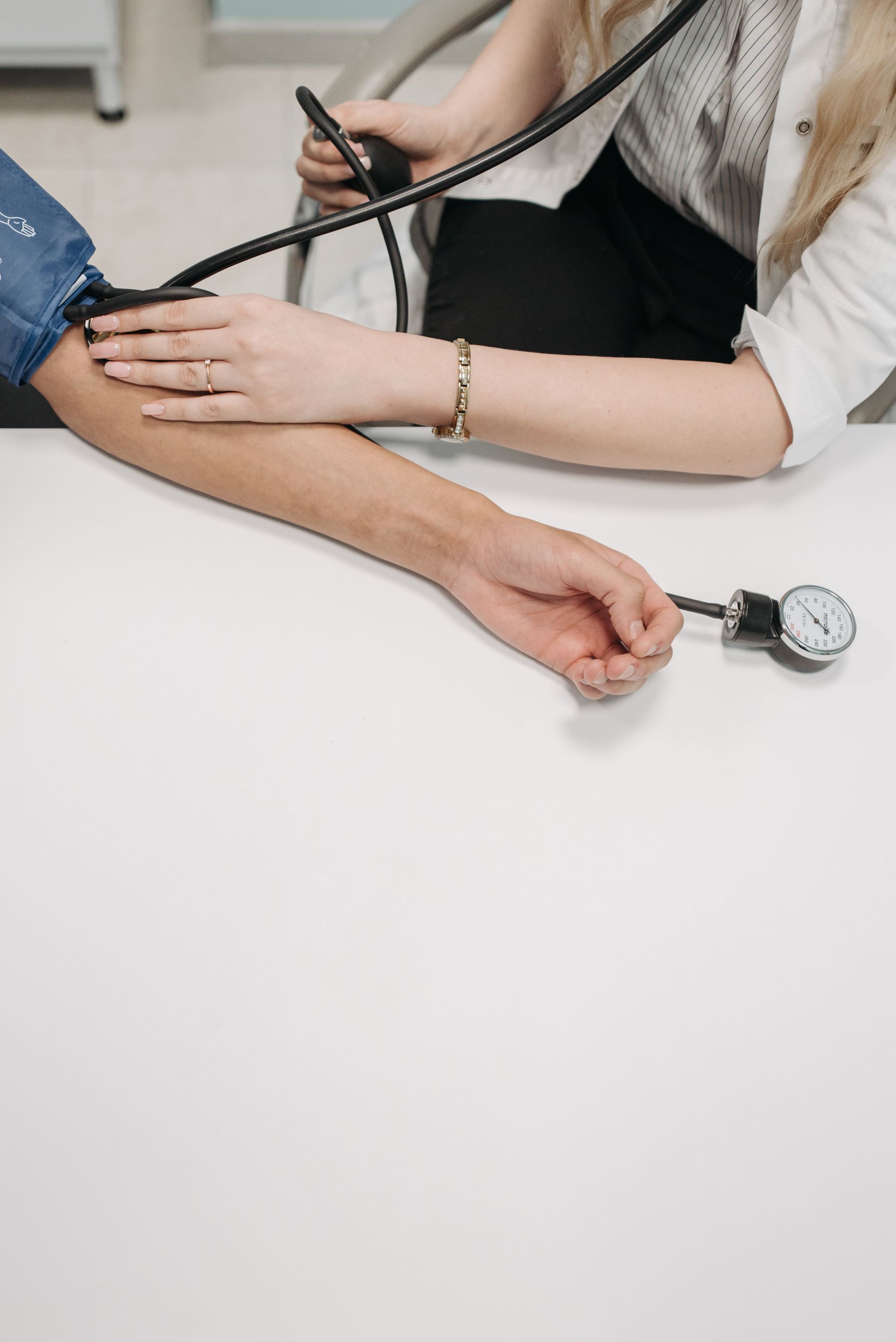 A medical practitioner monitoring a patient's blood pressure
