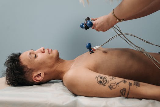 Man receiving heart examination with medical equipment in a healthcare facility.