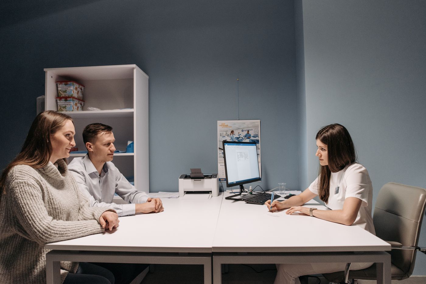 Couple discussing health needs with a medical professional