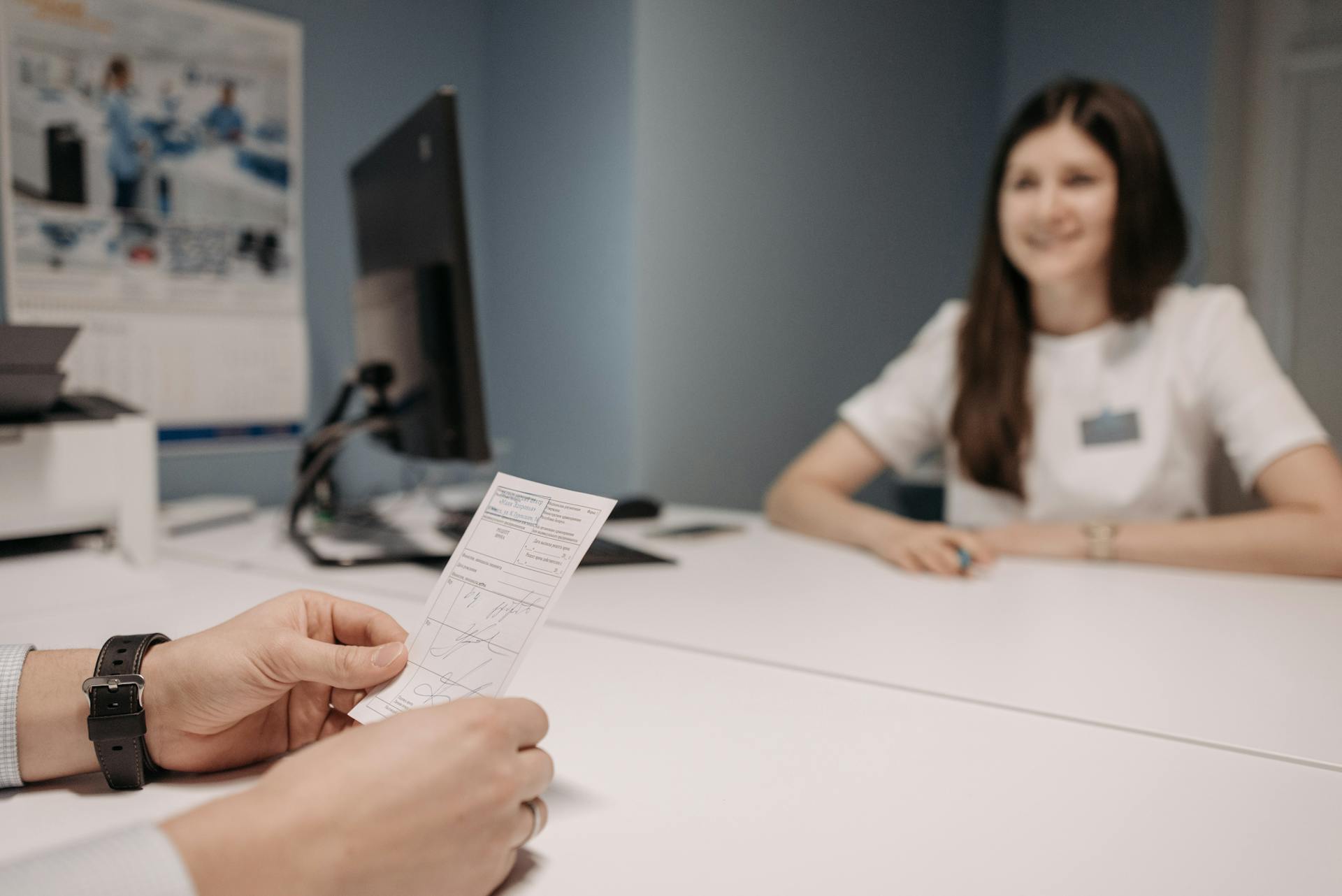 Woman doctor discussing patient's prescription in a clinic office setting.