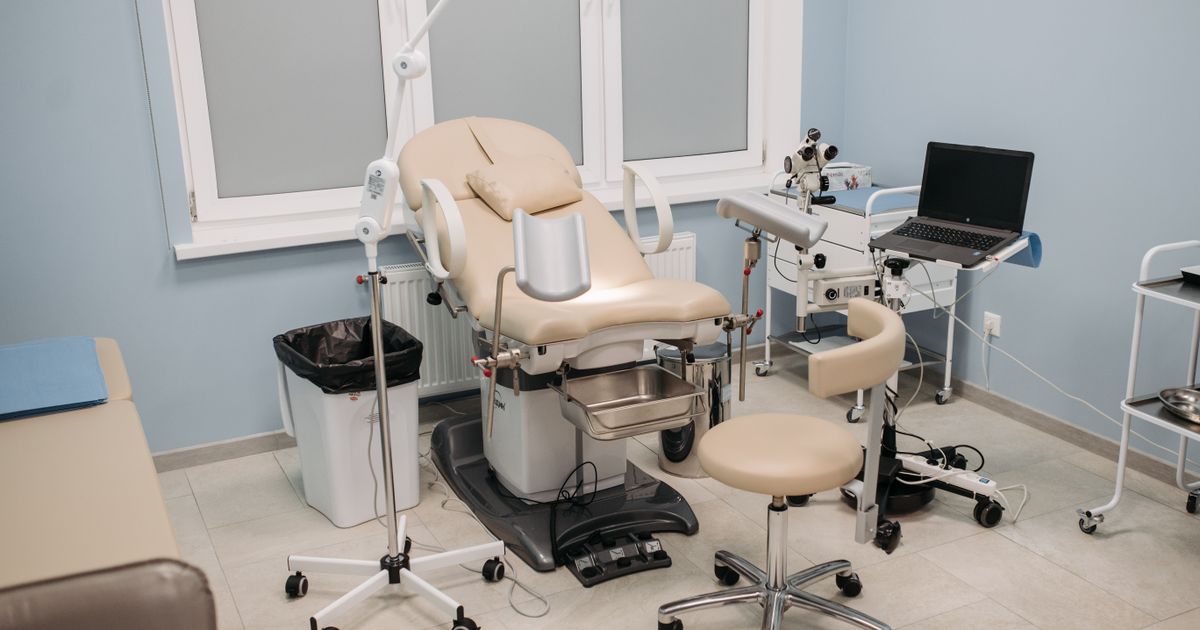 Clean well-equipped medical office with examination chair