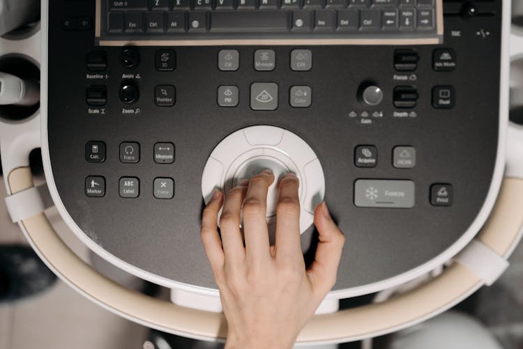 Close-Up Shot Of A Person Operating An Ultrasound Machine