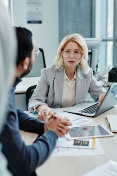Caucasian woman leading a business meeting in a modern office setting.
