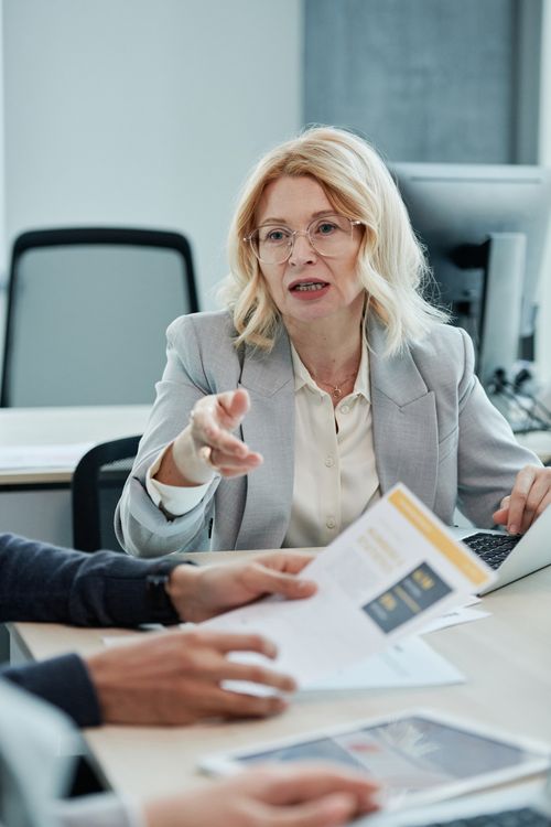Free Professional woman engaged in a business meeting, discussing and analyzing documents. Stock Photo
