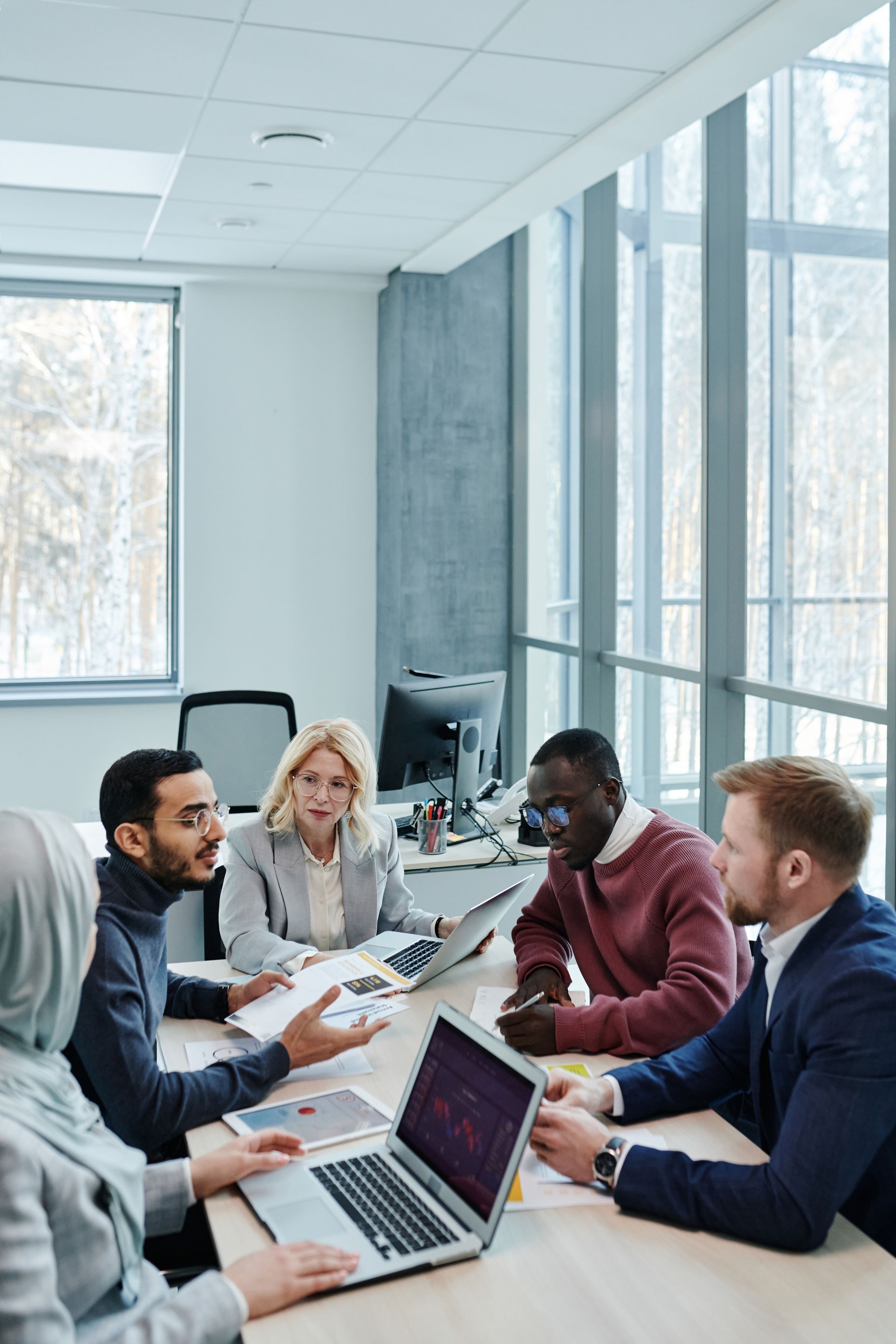 A diverse international team collaborating in a bright modern office