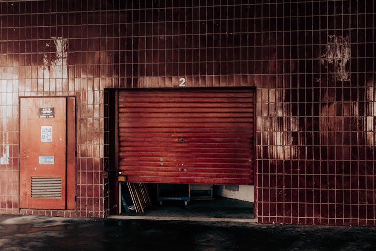 Old Garage With Shutter Under Number On Ceramic Wall