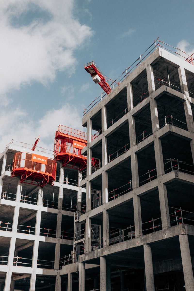 Construction site with cranes — modular GRP panels adapt to site constraints