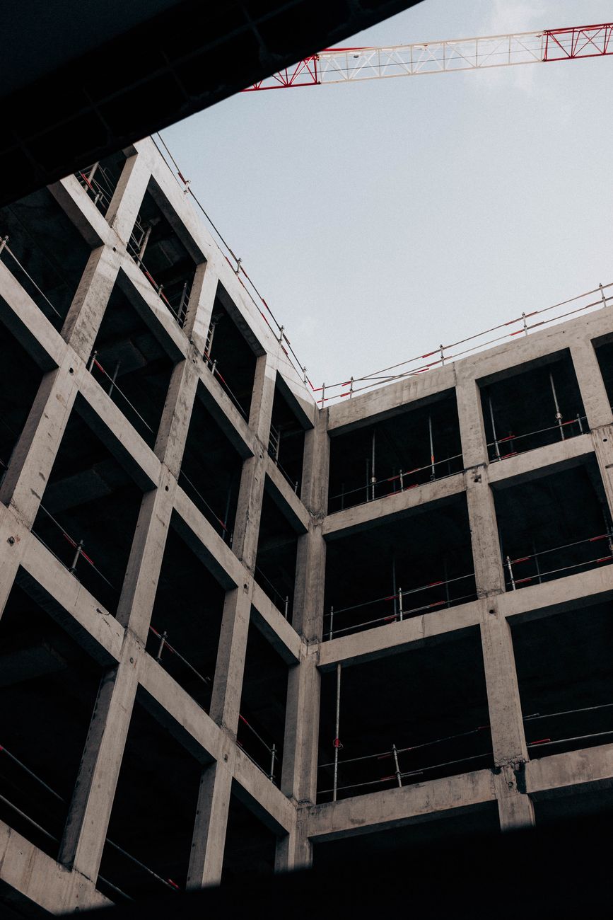 Low-angle view of an incomplete concrete building structure against the sky.