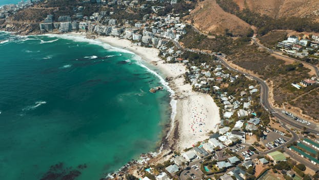 Stunning aerial shot of Cape Town's coastline with turquoise waters and beaches.
