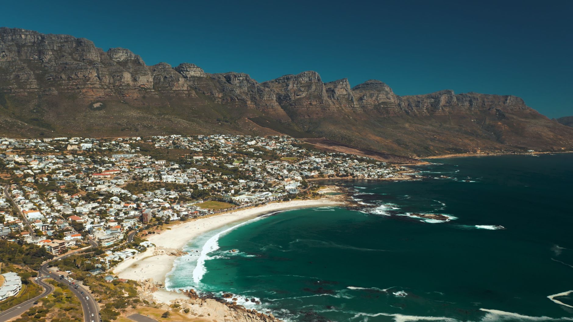 Breathtaking aerial view of Cape Town's coastline with the Twelve Apostles mountain range.