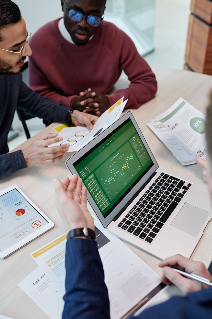 Team analyzing business data on a shared screen in an office