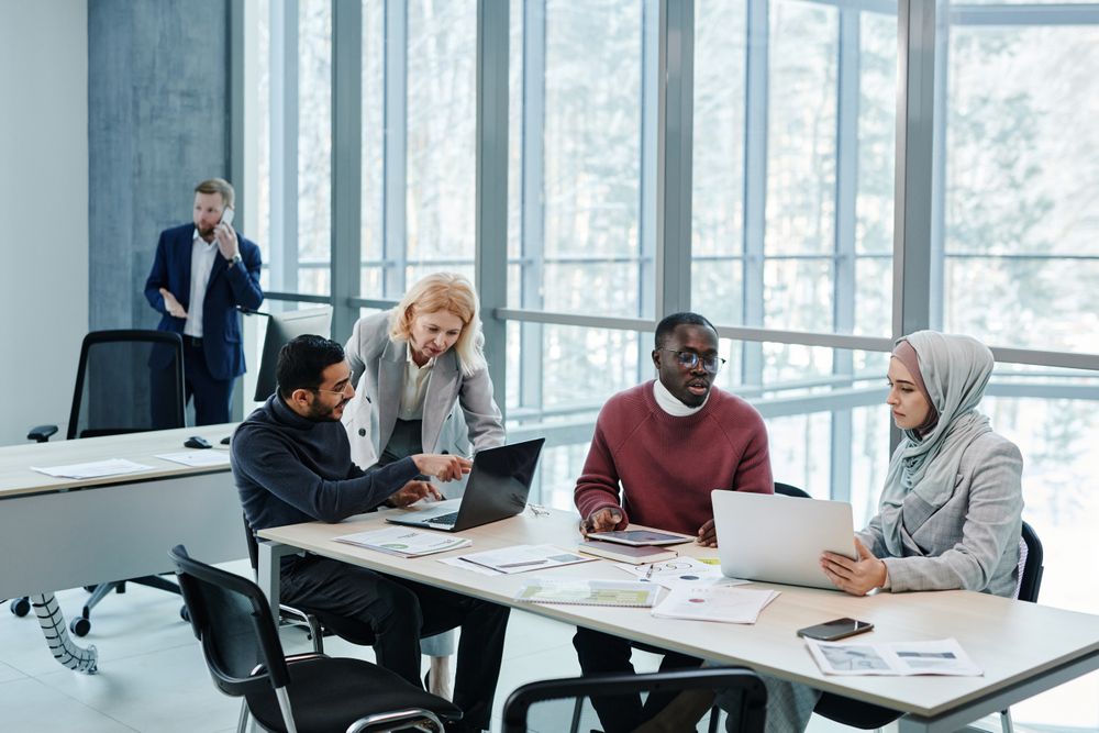 Halyard teammates reviewing a campaign together at a long table — photo by Tiger Lily on Pexels