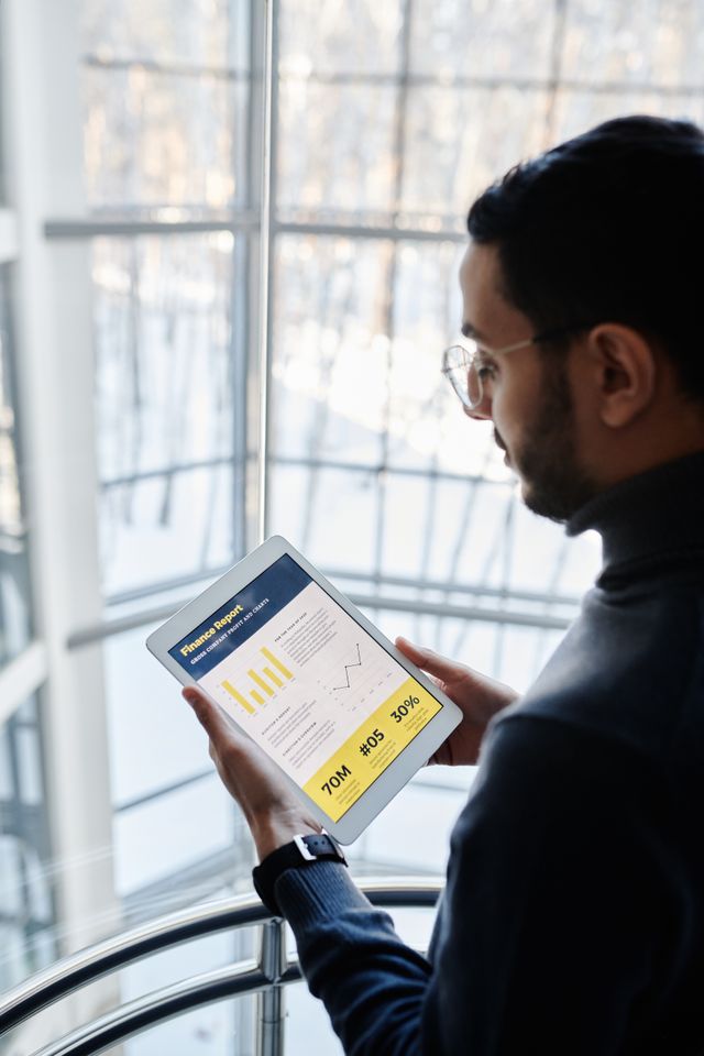 Business professional reviewing analytics report on tablet