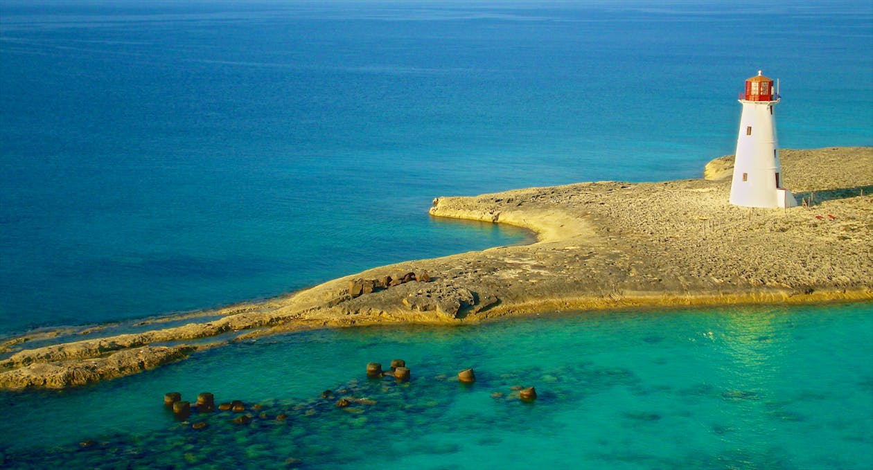 Bird's Eye Photography of White Lighthouse on Island