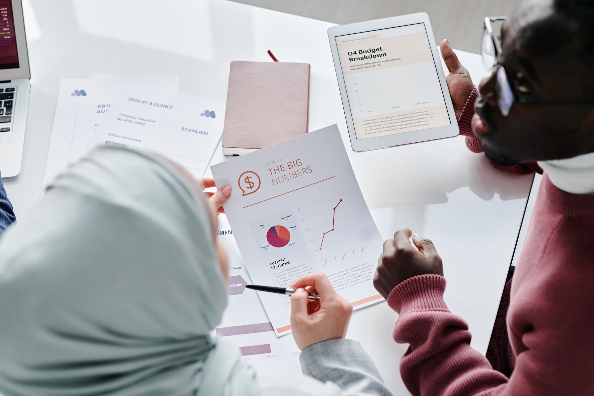 Two People Holding Documents