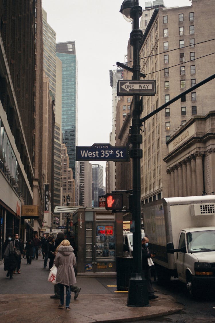 Many People Walking On Street With Modern Tall Buildings