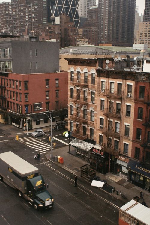 Free A high-angle view of city streets with buildings, traffic, and pedestrians. Stock Photo