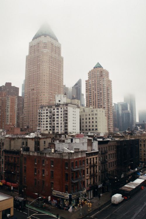 Free Moody urban view of New York City skyline shrouded in fog with prominent skyscrapers. Stock Photo