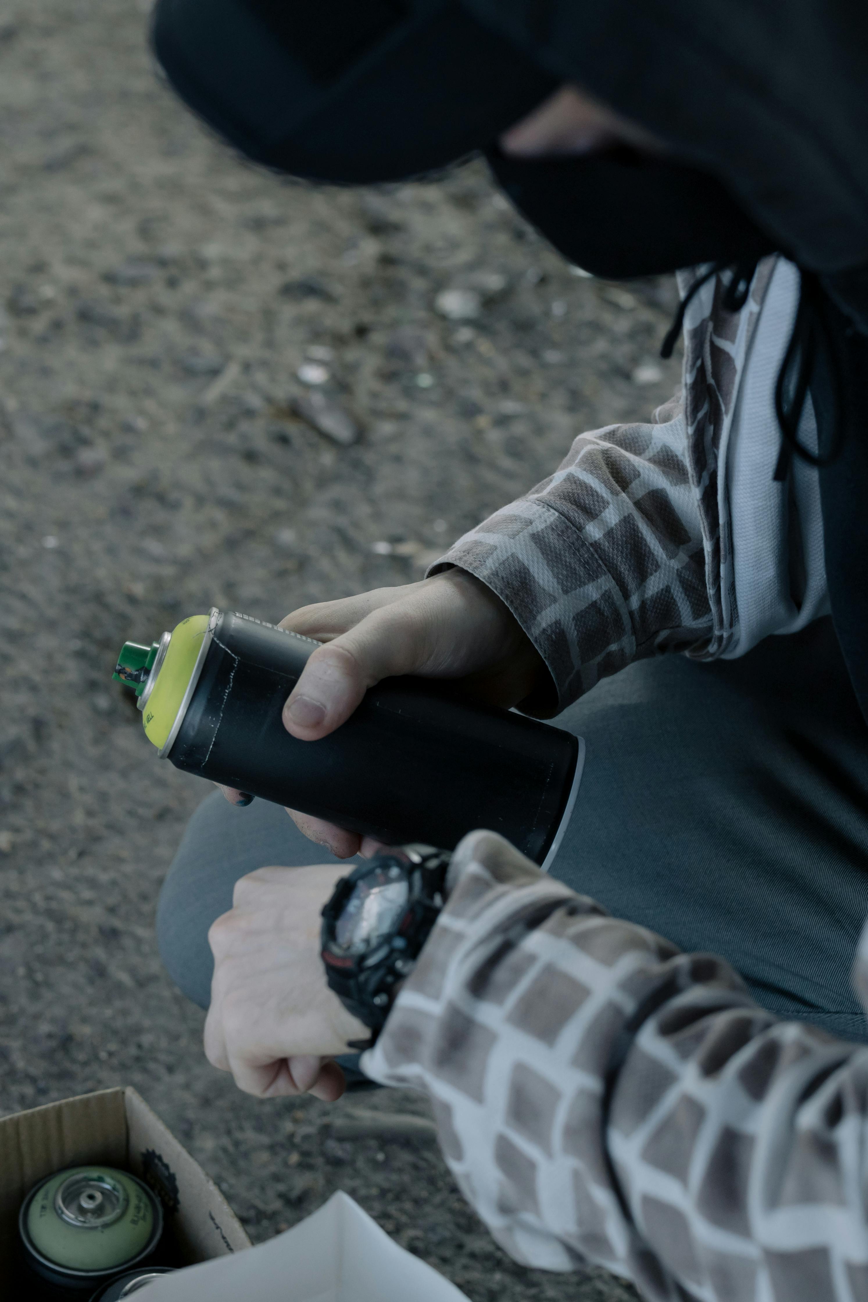 Person Holding Green and Black Bottle \u00b7 Free Stock Photo