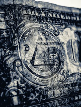 Detailed close-up of the Eye of Providence pyramid on an American dollar bill, symbolizing financial concepts.