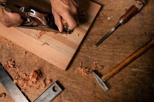 Free A Person using a Wood Planer Stock Photo
