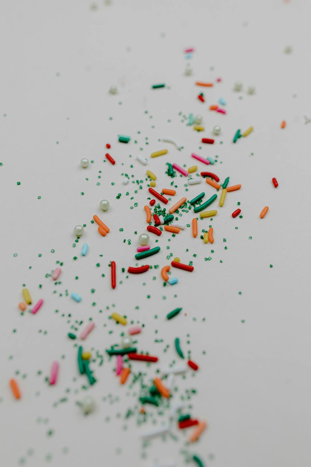 Colorful Sprinkles on White Surface · Free Stock Photo