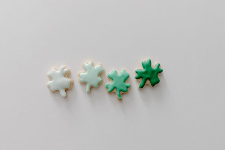 Green And White Icing Cookies On White Surface