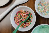 Green and White Plastic Bowls With Green Plastic Spoons