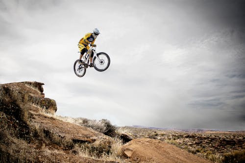 Free Person Riding Bike Making Trek on Thin Air Stock Photo