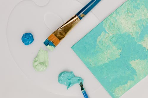 Paintbrushes With Acrylic Paint on White Surface