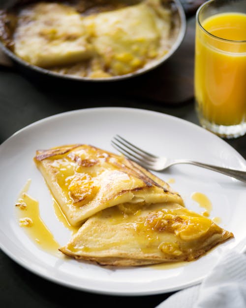 Delicious breakfast crepes placed on table