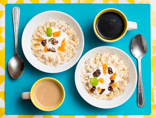 Breakfast for Two Served in Plates with Coffee Cups and Spoons 