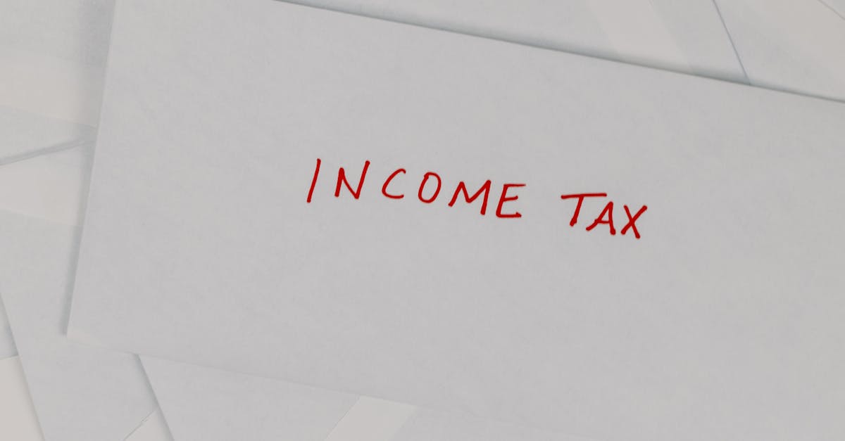 Photo by Tara Winstead Top-down view of an envelope labeled 'Income Tax' on a white background, representing finance and taxation.