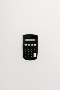 A black calculator placed on a white background, ideal for financial and accounting themes.