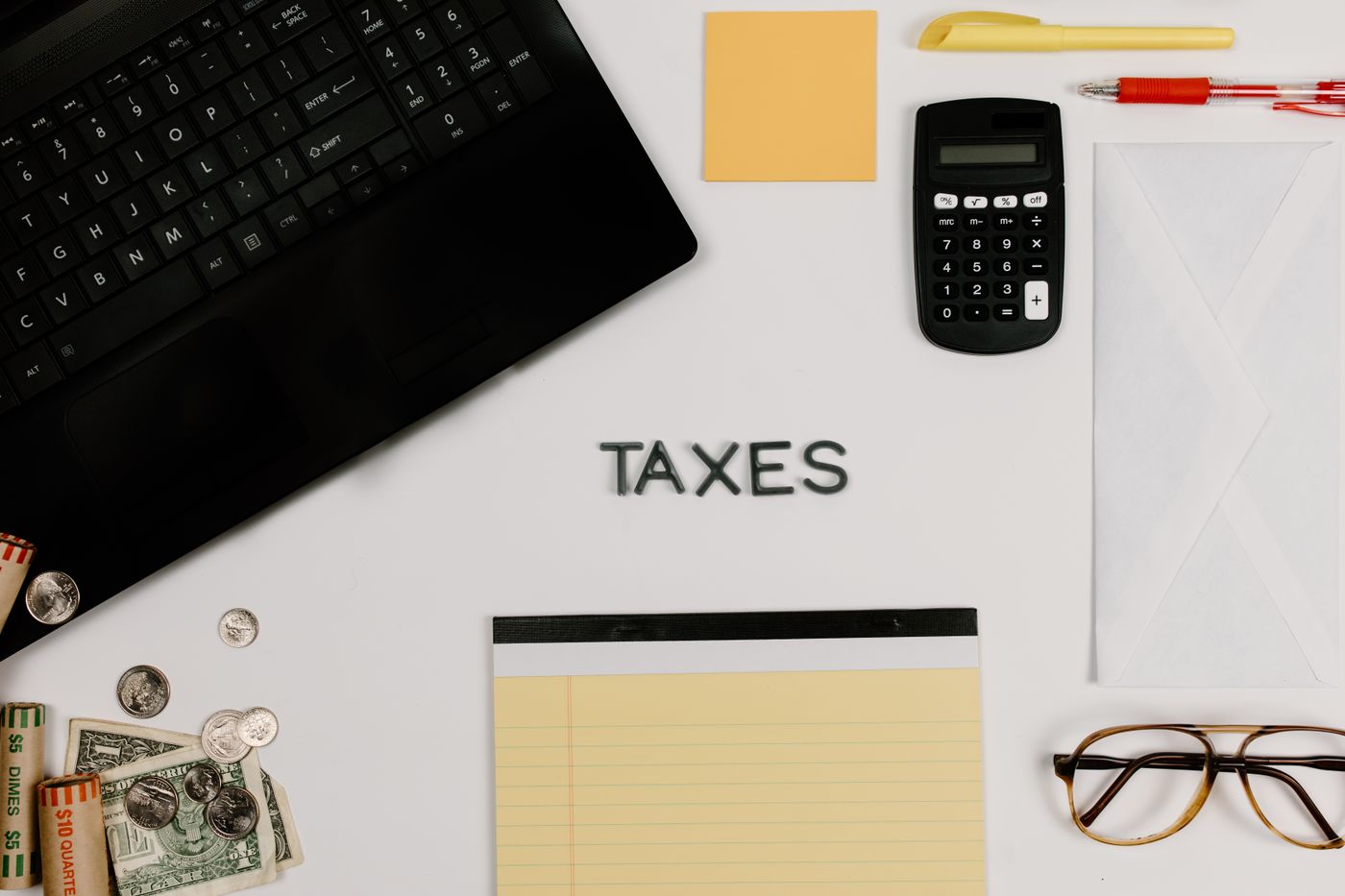 Calculator, laptop and notebook used for planning an 18-month personal loan